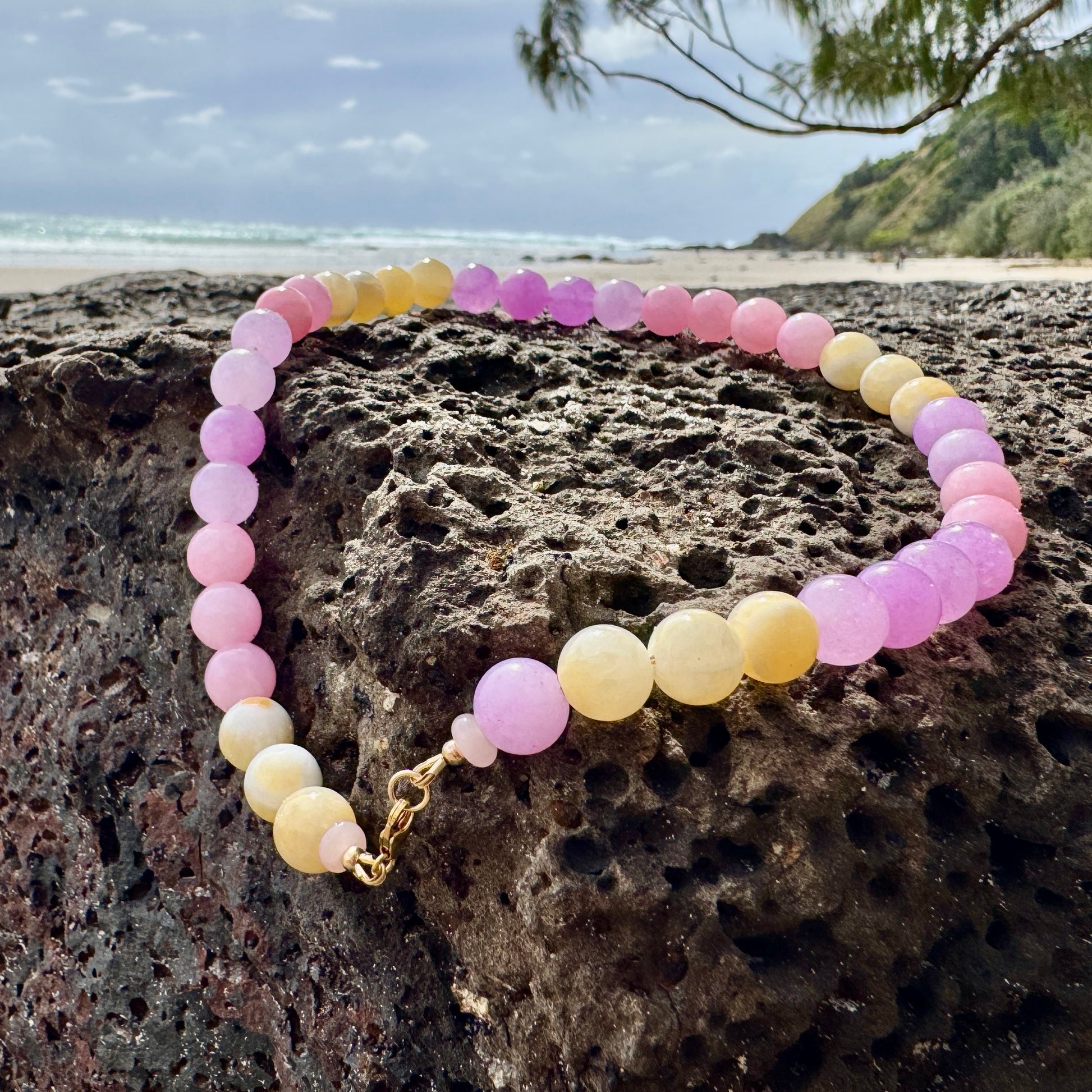 Pink and honey statement necklace worn at the collarbone, handmade by elsket